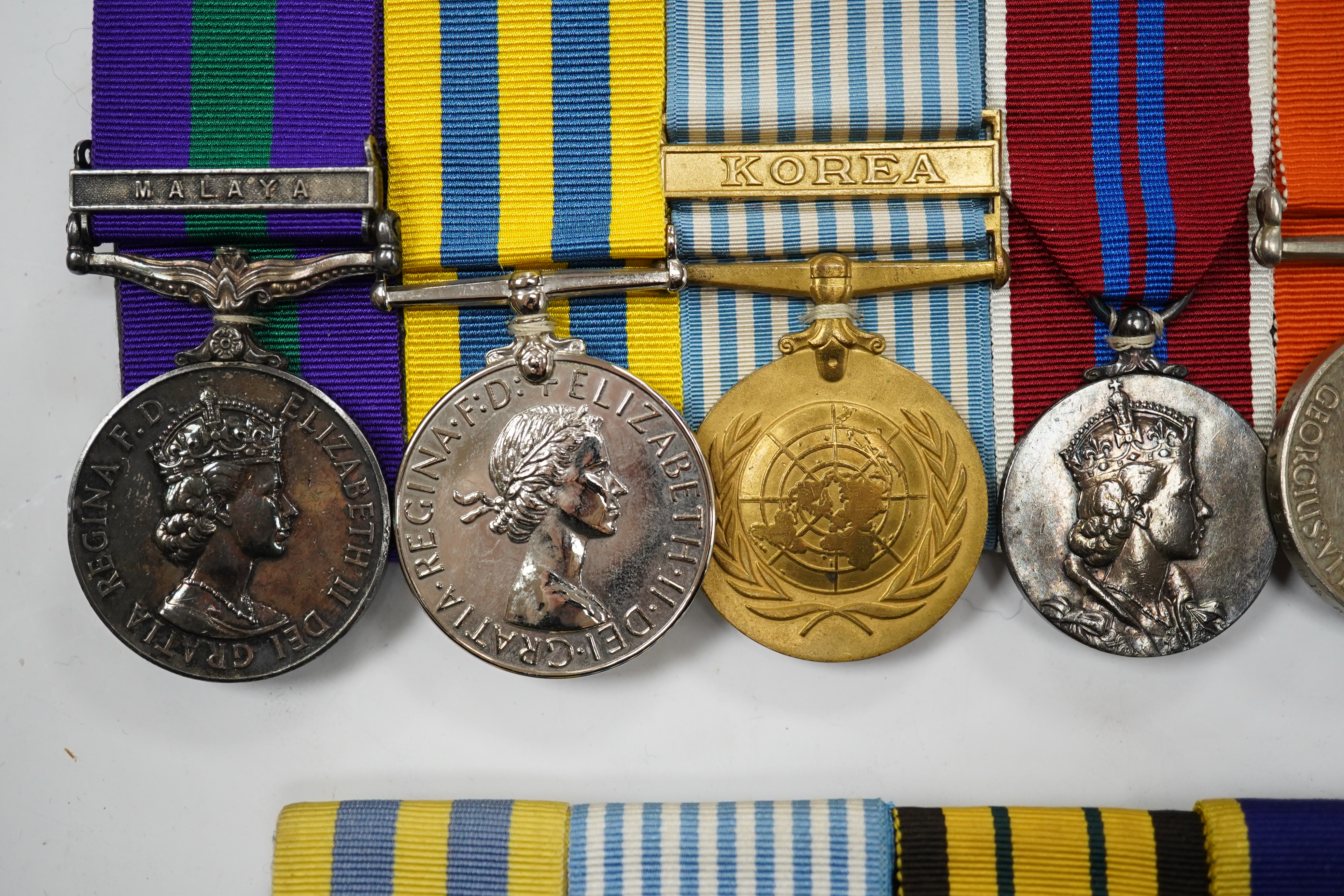 Twelve ERII and George VI medals, some medals arranged into two medals groups (containing unnamed medals and medals awarded to different recipients within the same group), including